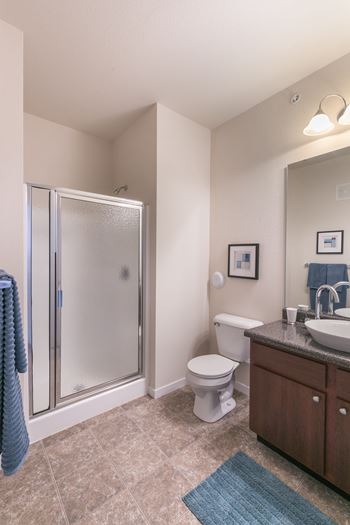 A bathroom with a toilet, sink, and shower.